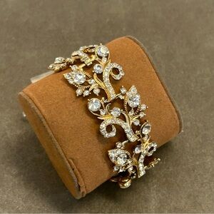 gold-tone costume bracelet with clear rhinestones in a floral vine-like design